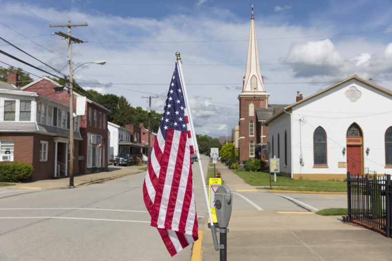 American flag flying on a quiet main street in rural Ohio.