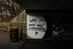 "Let's love our community" with a heart in graffiti under a bridge in Dayton Ohio