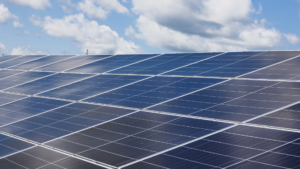 Solar panels and a blue sky with clouds in the background